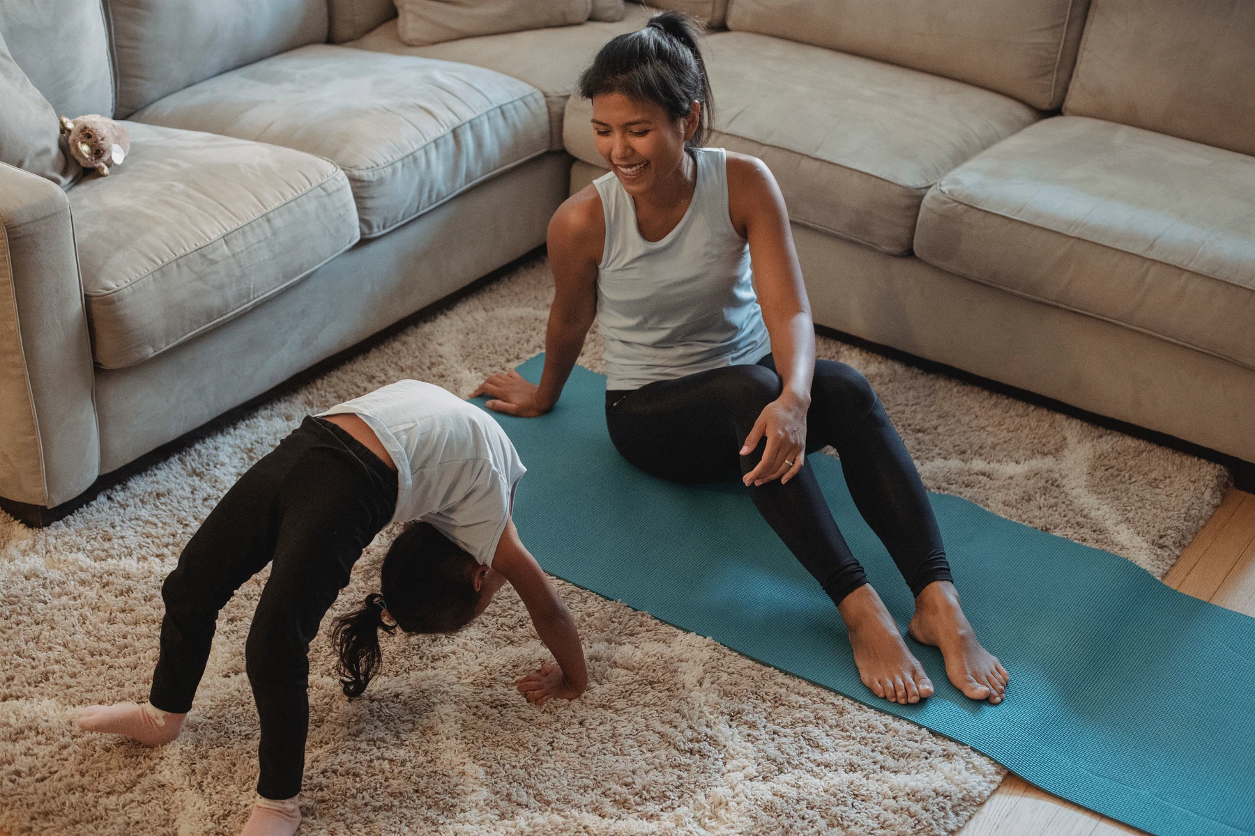 A mother and daughter move together in their living room