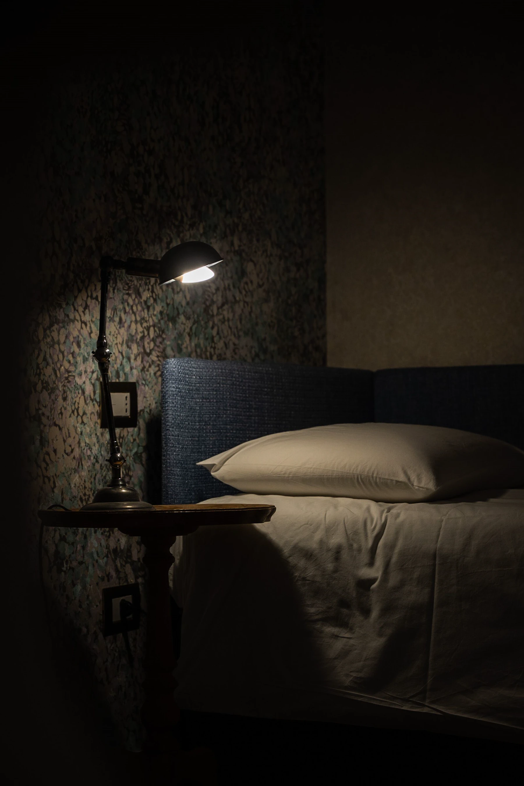 A warm bedside lamp creates a quiet evening setting