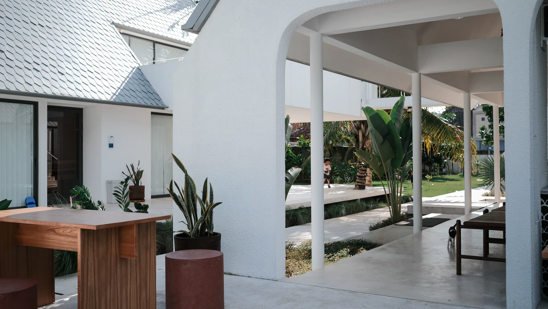 An open-air courtyard connects a family home with shade, plants and fresh air