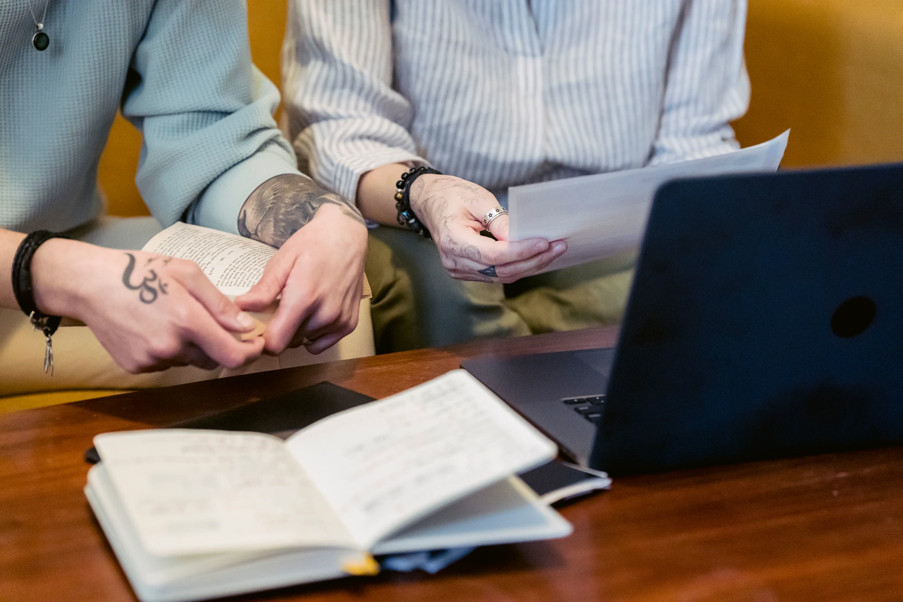 A group reviews reports, notes and source material together at a table