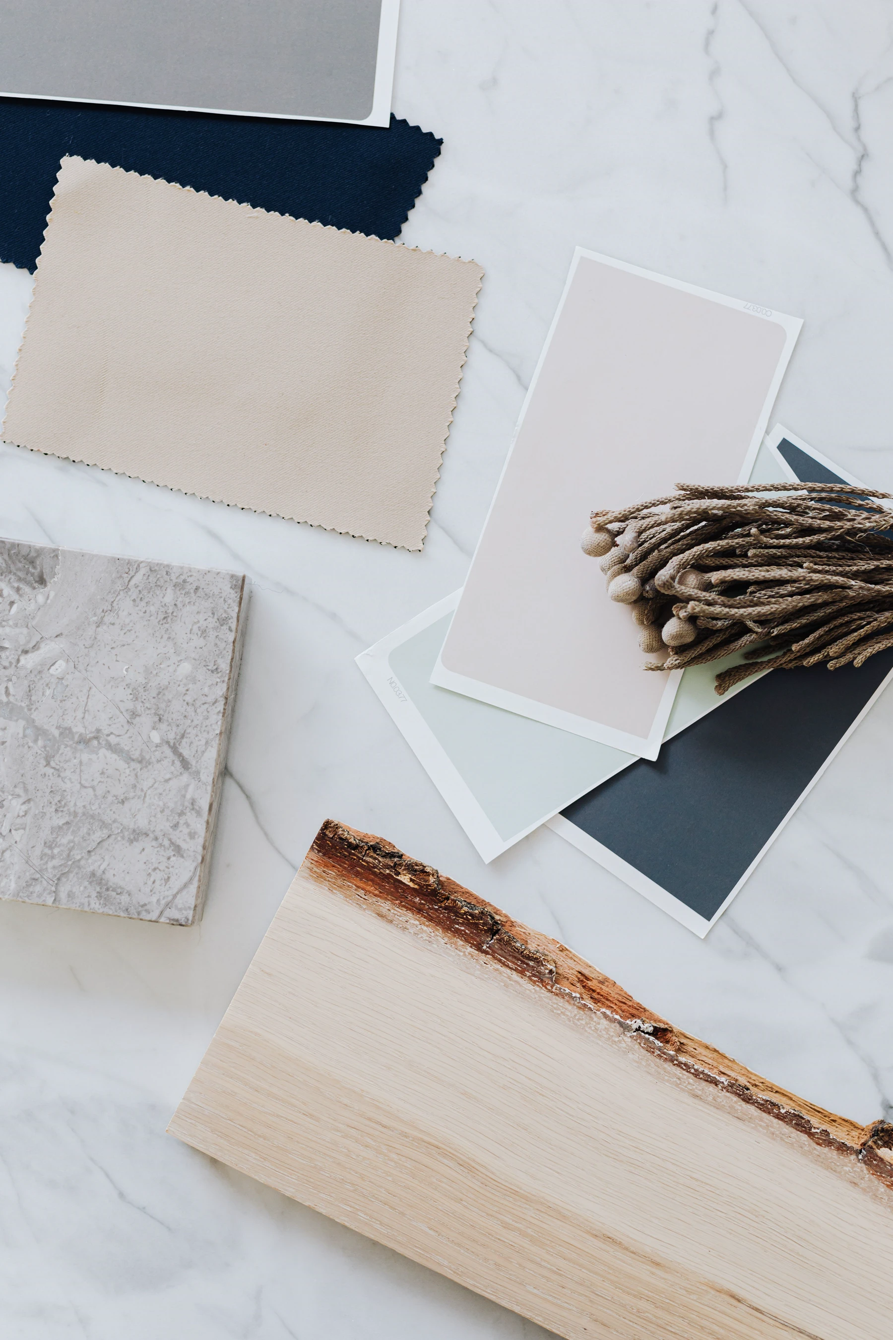 Stone, timber, textile and finish samples laid out together.